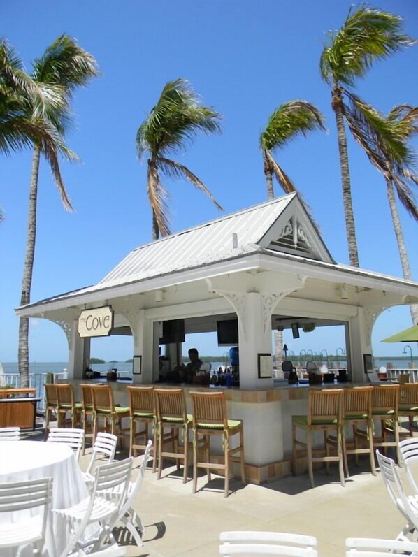 A beachside cafe named "Cove" with outdoor seating and a view of the ocean. - Resort Harbour Properties (Fort Myers)