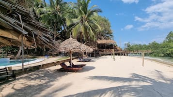 On the beach, sun-loungers, beach umbrellas, beach towels
