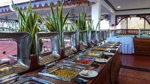 A buffet setup with various food stations, including trays of hot dogs, salads, and other dishes. - Maru Maru Hotel (Zanzibar Town)