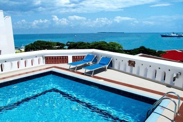 Outdoor pool, pool umbrellas, sun loungers