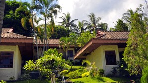 A tropical resort with a staircase leading to a building, surrounded by lush greenery and palm trees. - Puri Bunga Senggigi (Senggigi)