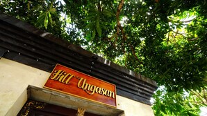 A sign with the name "Hill Ungasan" above a doorway.