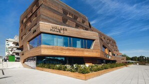 Un edificio moderno con fachada de madera y ventanas amplias.