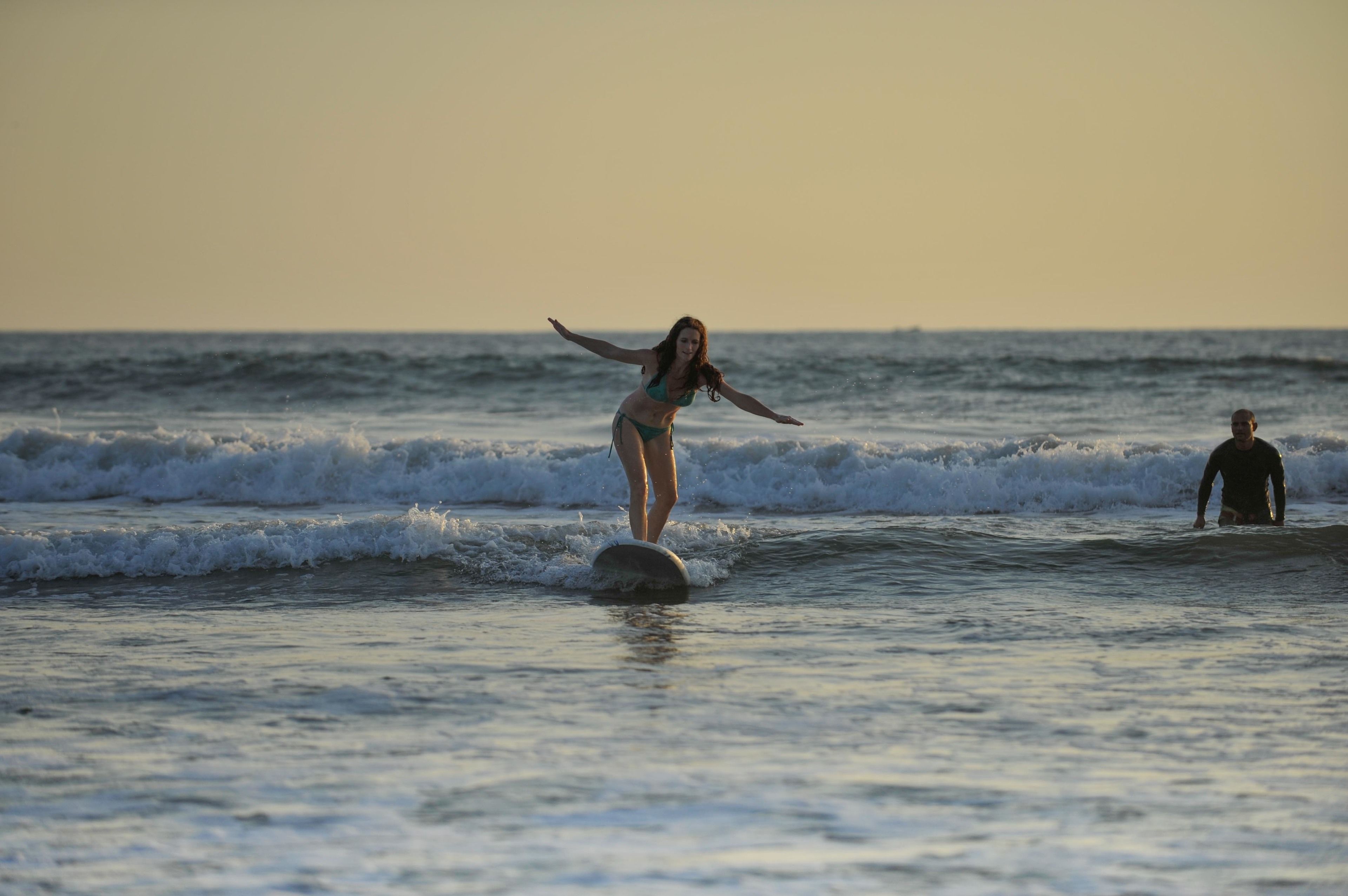 A person surfing on a wave in the ocean.