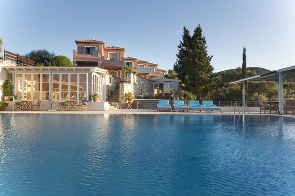 Outdoor pool, open 7:00 AM to 11:00 PM, pool umbrellas, sun loungers