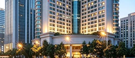 A high-rise hotel with a modern architectural design, featuring a prominent curved facade and multiple floors.