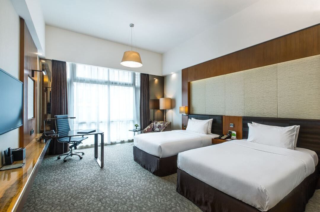 deluxe twin room | in-room safe, desk, blackout curtains, iron/ironing board