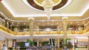 A spacious atrium with a grand chandelier, multiple levels, and a central fountain. - Empark Grand Hotel (Xishuangbanna Dai)