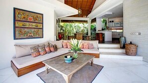 A spacious living area with a sofa set, a coffee table, and a painting on the wall. - Villa Sahaja (Kerobokan)