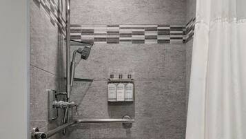 A modern shower with a handheld showerhead, a rain showerhead, and a handheld shower attachment.