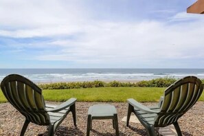 Two Adirondack chairs facing a beach with ocean views. - Hallmark Resort - Newport (Newport)