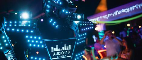 A DJ booth with LED lights and a label reading "AUDIO110 S.A. DE C.V."