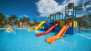 A water park with multiple slides and a pool.
