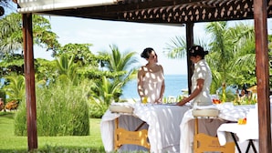 A massage table set up outdoors with a view of the ocean and tropical vegetation. - Hotel Riu Palace Costa Rica - All Inclusive (Sardinal)