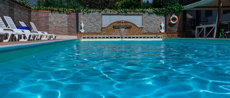 Seasonal outdoor pool, pool loungers