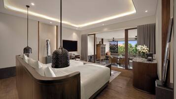 A modern hotel room with a large bed, a desk, and a balcony with a view.