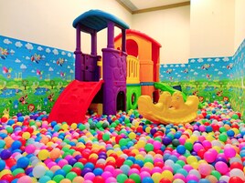 A children's play area with a ball pit and a colorful play structure.