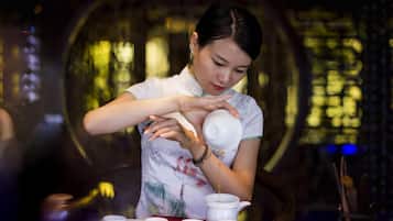 A person pouring tea into a cup.