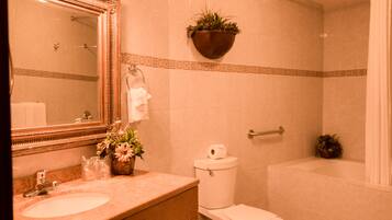 A bathroom with a sink, toilet, and bathtub.