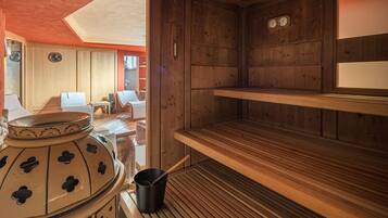 A sauna room with wooden benches, a large ceramic pot, and a wooden shelf.