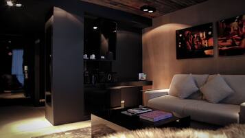 A modern living room with a sofa, a coffee table, and a bookshelf.