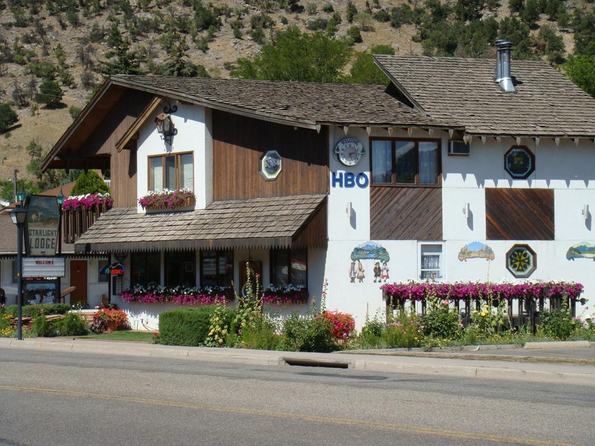 A two-story building with a sign reading "HBO" on the side.