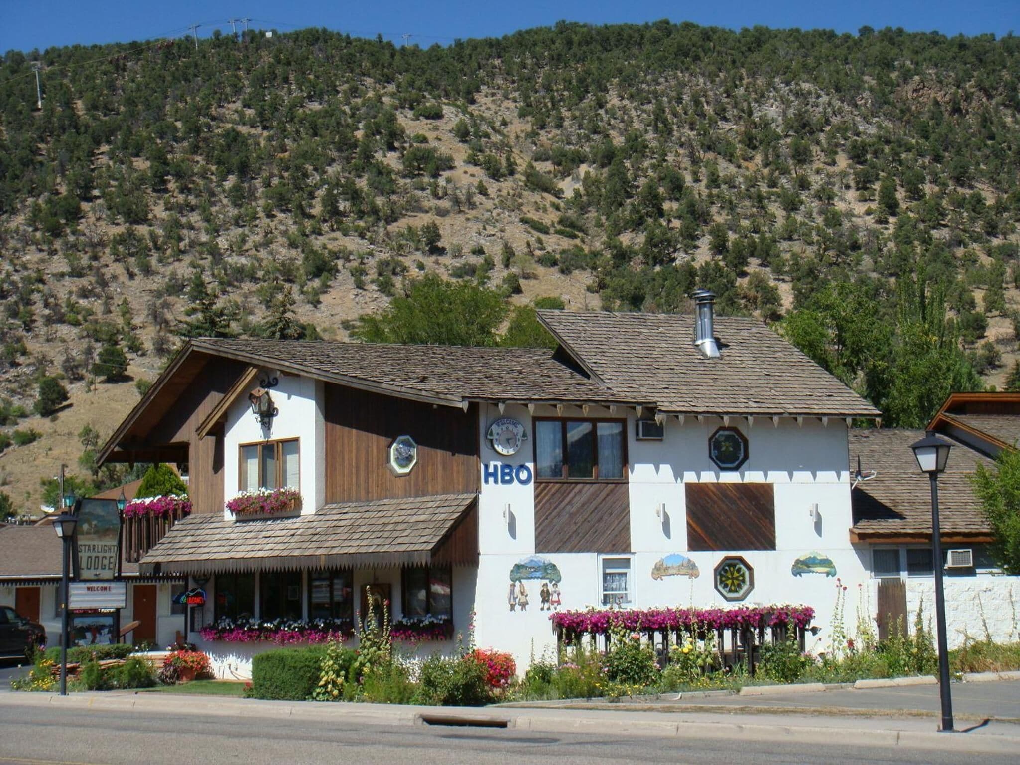 A two-story building with a sign that reads "HBO" on the side.