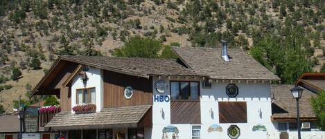 A two-story building with a sign that reads "HBO" on the side.