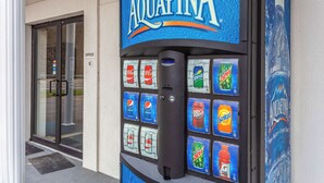 A vending machine with a sign reading "AQUAFINA" and various beverage options including Pepsi, Coca-Cola, Sprite, and Dr. Pepper. - Motel 6 Huntington, WV (Huntington)