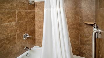 A modern bathroom with a bathtub, shower, and a curtain.