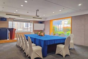 A conference room with a long table, white chairs, a podium, and a large window. - Elong ME Hotel (Changsha Zhongmao City) (Changsha)