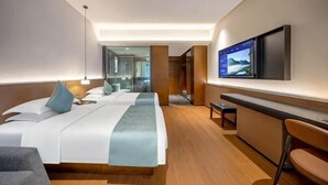 A modern hotel room with a large bed, a desk, a TV, and a mirror. - Elong ME Hotel (Changsha Zhongmao City) (Changsha)