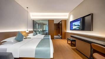 A modern hotel room with a large bed, a desk, a TV, and a mirror.