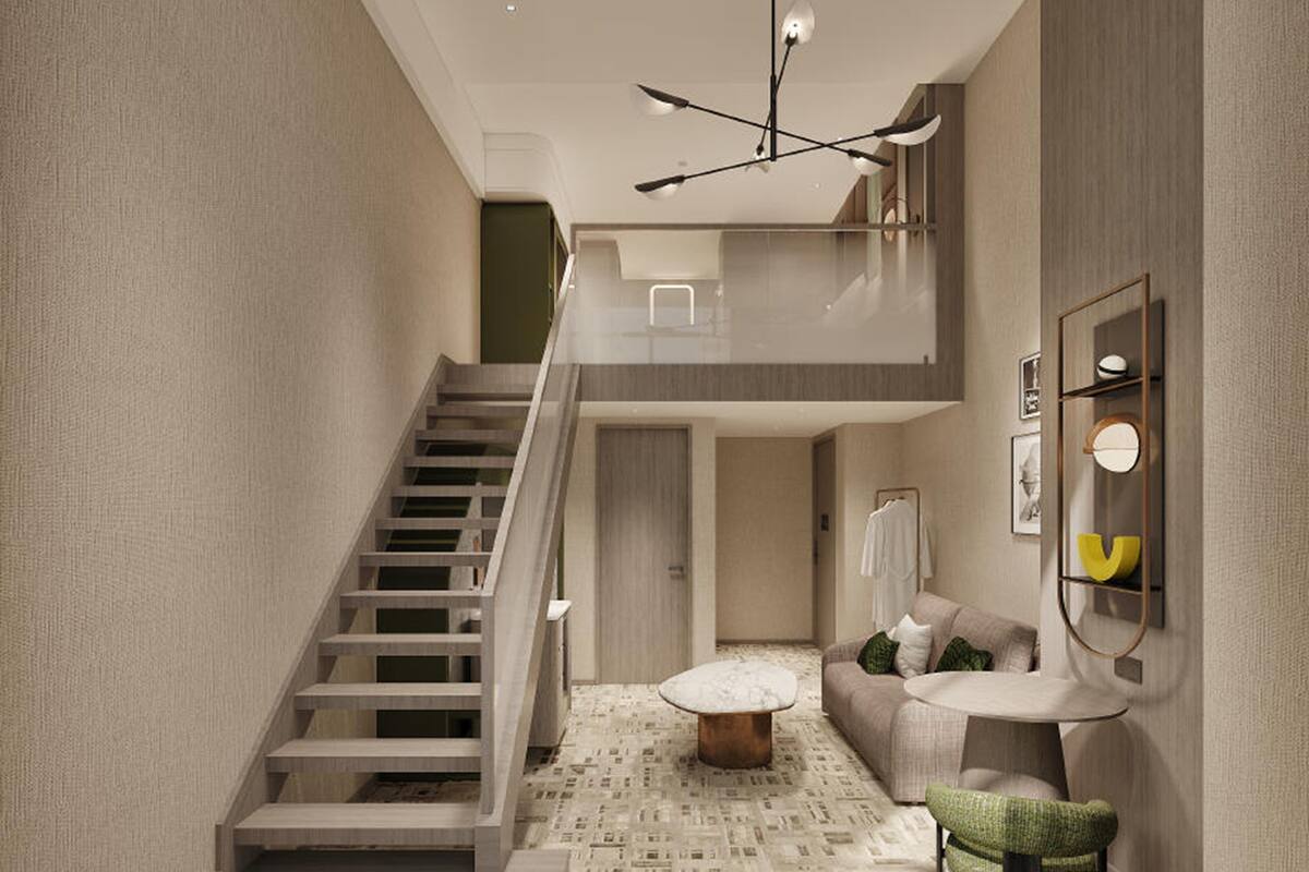 A modern interior with a staircase, a sofa, a coffee table, and a wall-mounted shelf.