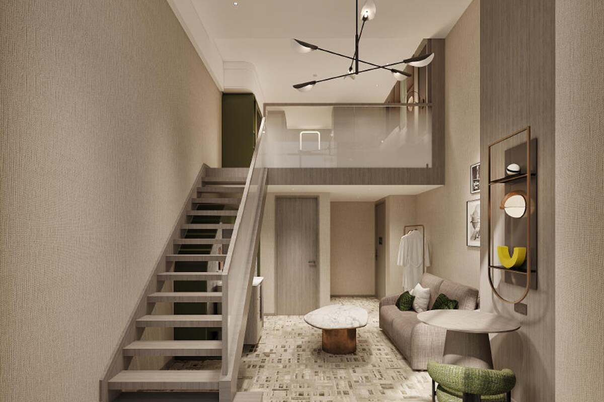 A modern interior with a staircase, a sofa, a coffee table, and a wall-mounted shelf.