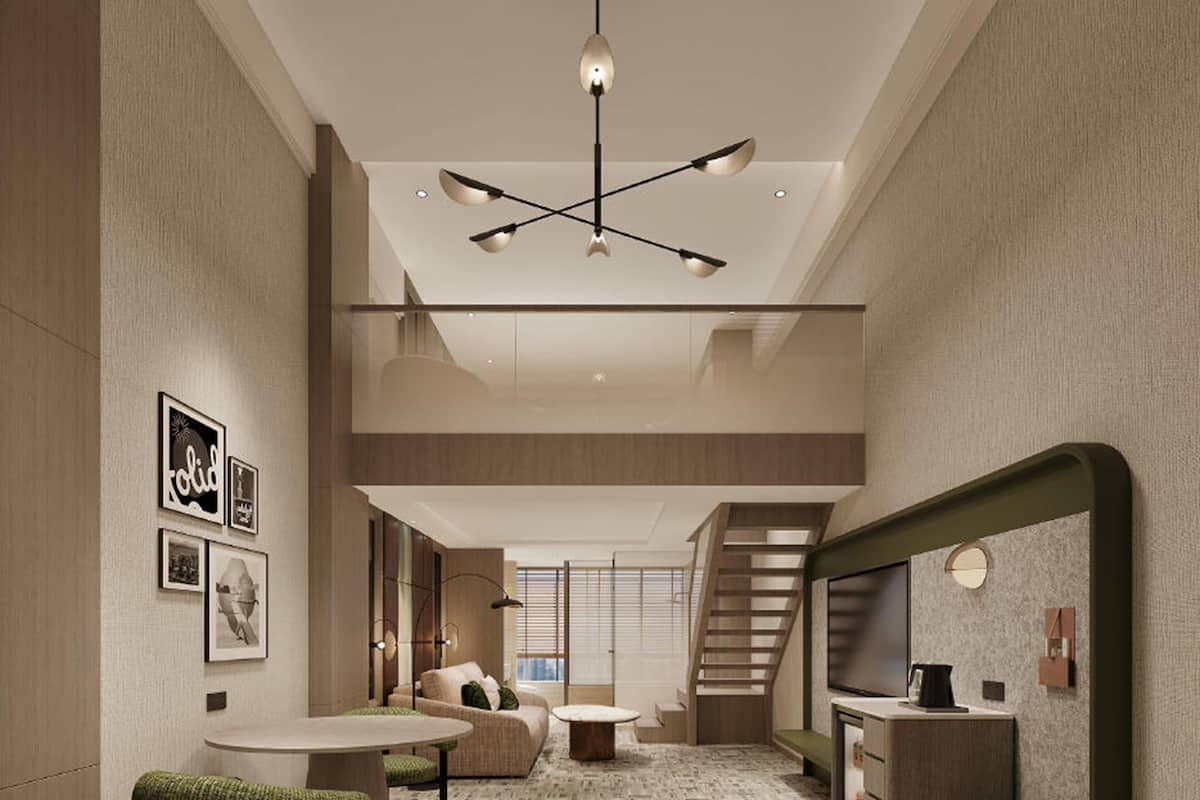 A modern interior with a staircase, a dining area, and a kitchenette.