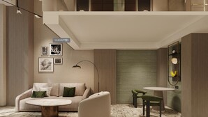 A modern living room with a sofa, armchair, coffee table, and a small round table. - Holiday Inn Hefei City Center by IHG (Hefei)