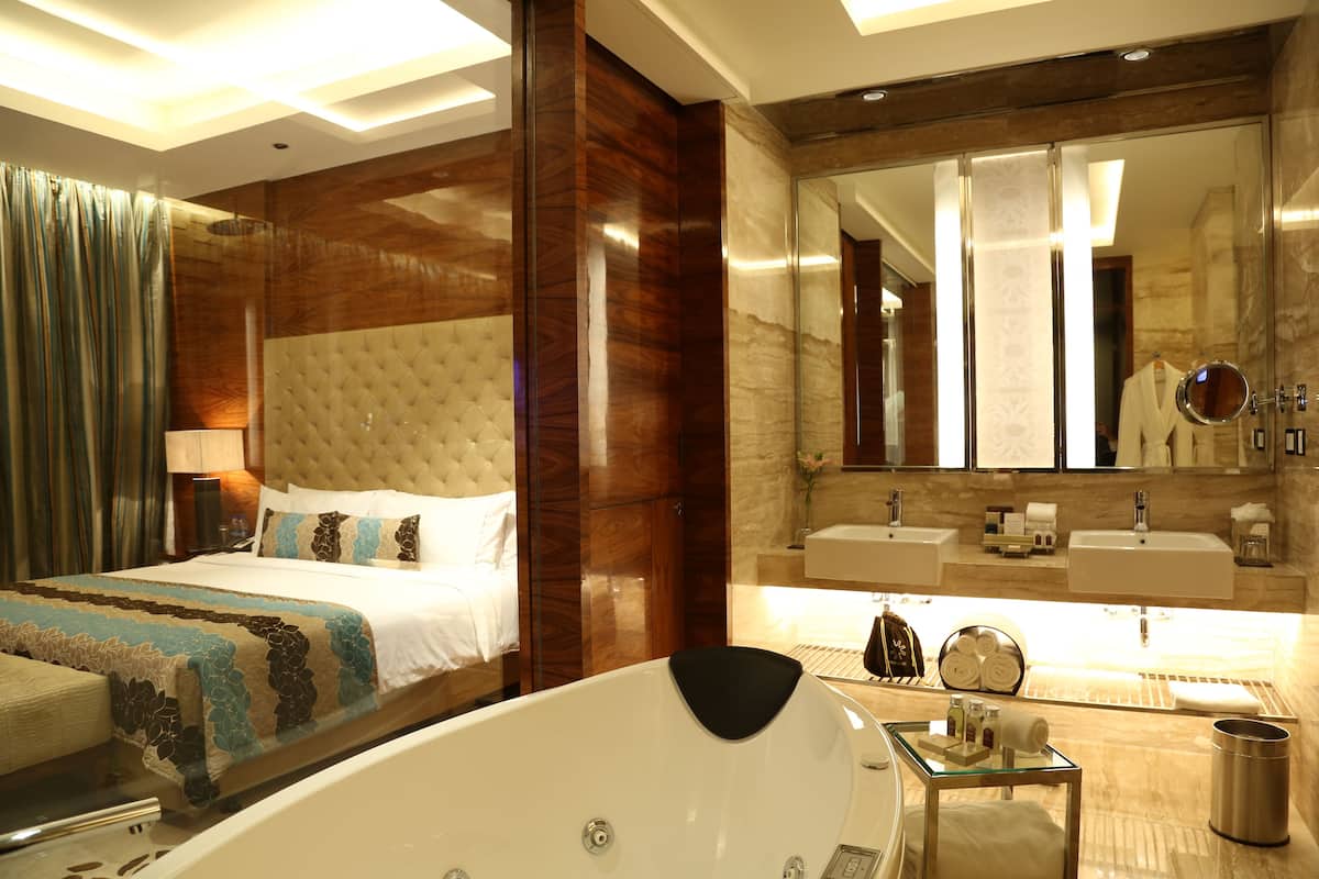 executive suite, 1 king bed | bathroom | separate bathtub and shower, rainfall showerhead, designer toiletries