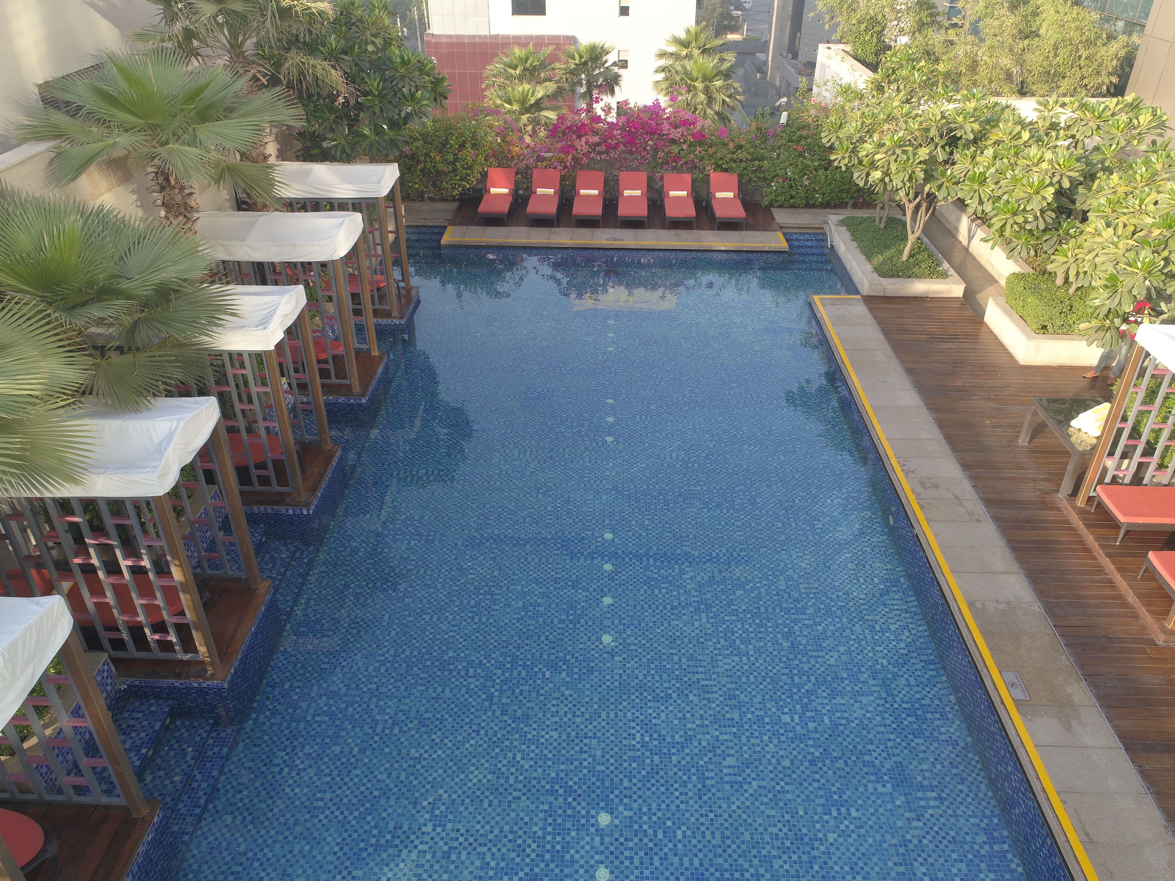 outdoor pool, open 7:00 am to 8:00 pm, pool umbrellas, pool loungers