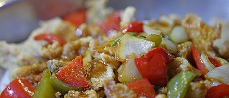 A close-up of a stir-fry dish with vegetables and meat in a pan.