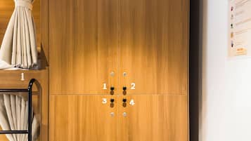 A wooden wardrobe with a number lock system and a ladder for storage.