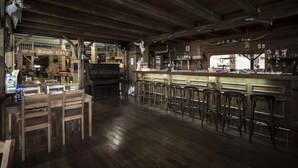 A rustic bar area with wooden furniture and a sign reading "Rock City".