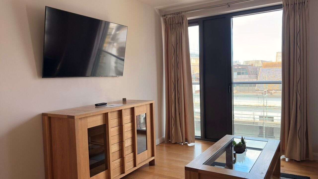 One Bedroom Apartment – Town View Deluxe | Living area | 55-inch TV with digital channels