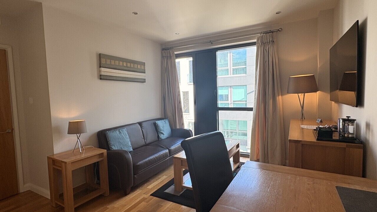 One Bedroom Apartment, Town View | Living area | 55-inch TV with digital channels