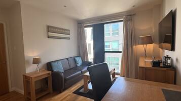 One Bedroom Apartment, Town View | Living area | 55-inch TV with digital channels