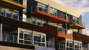 A multi-story building with balconies, large windows, and a modern architectural design. - St Kilda Central Apartment Hotel (St Kilda)