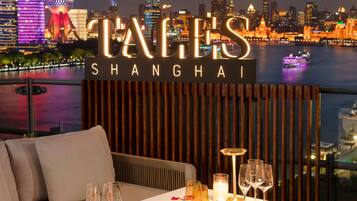 A table set for dining with a city skyline in the background.