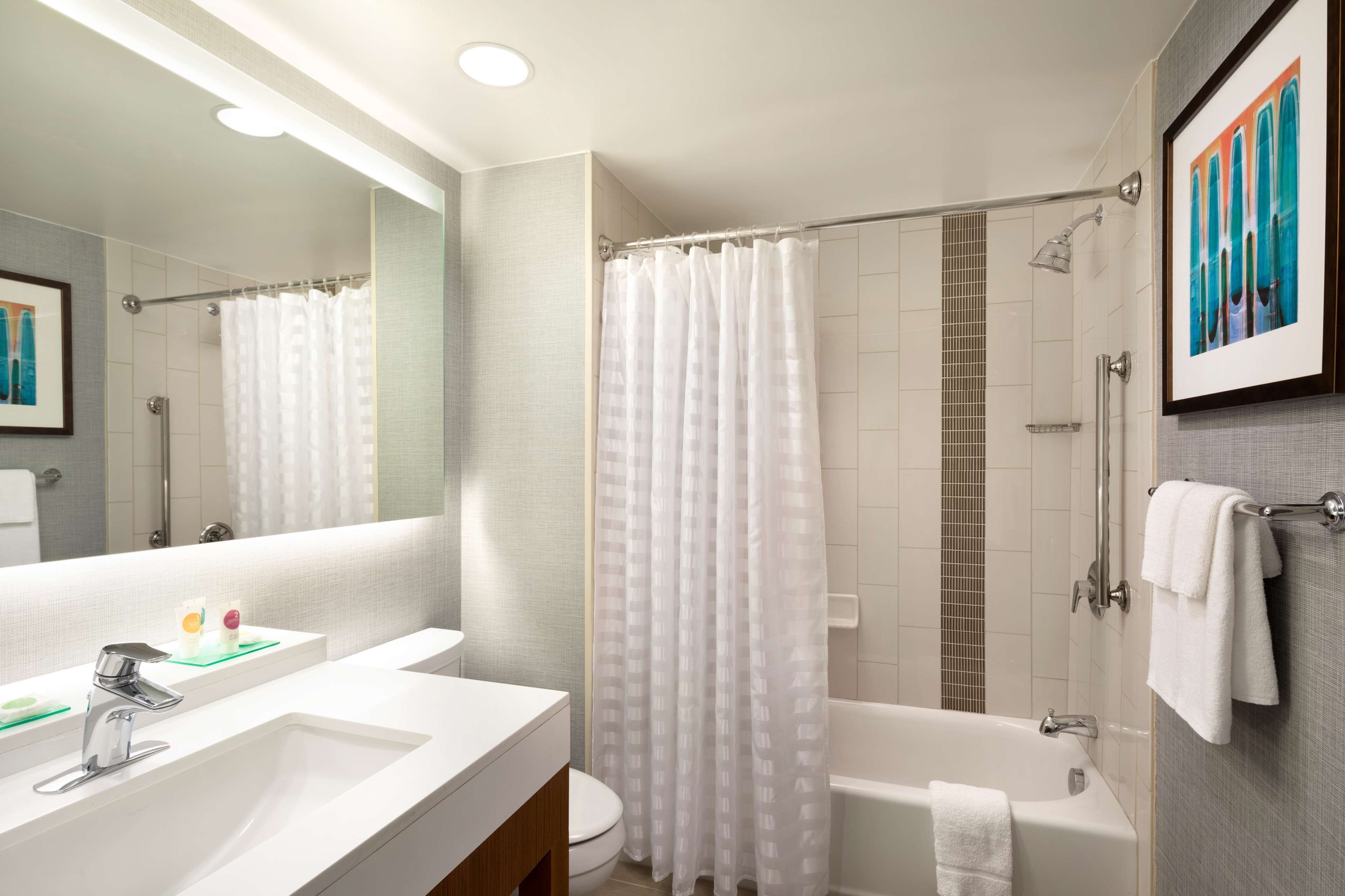 designer toiletries, hair dryer, towels