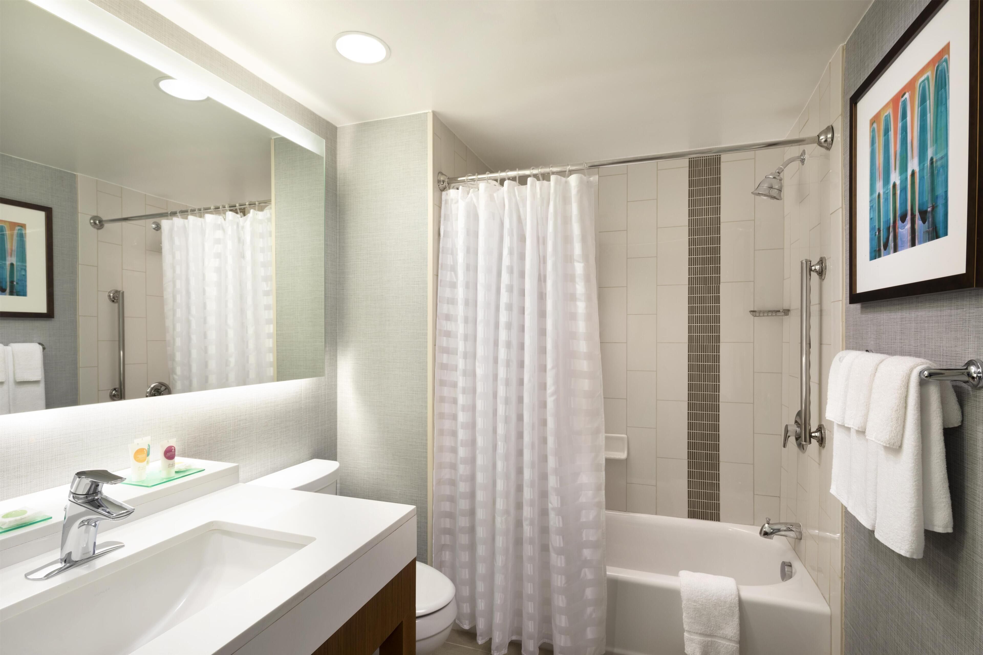 Designer toiletries, hair dryer, towels