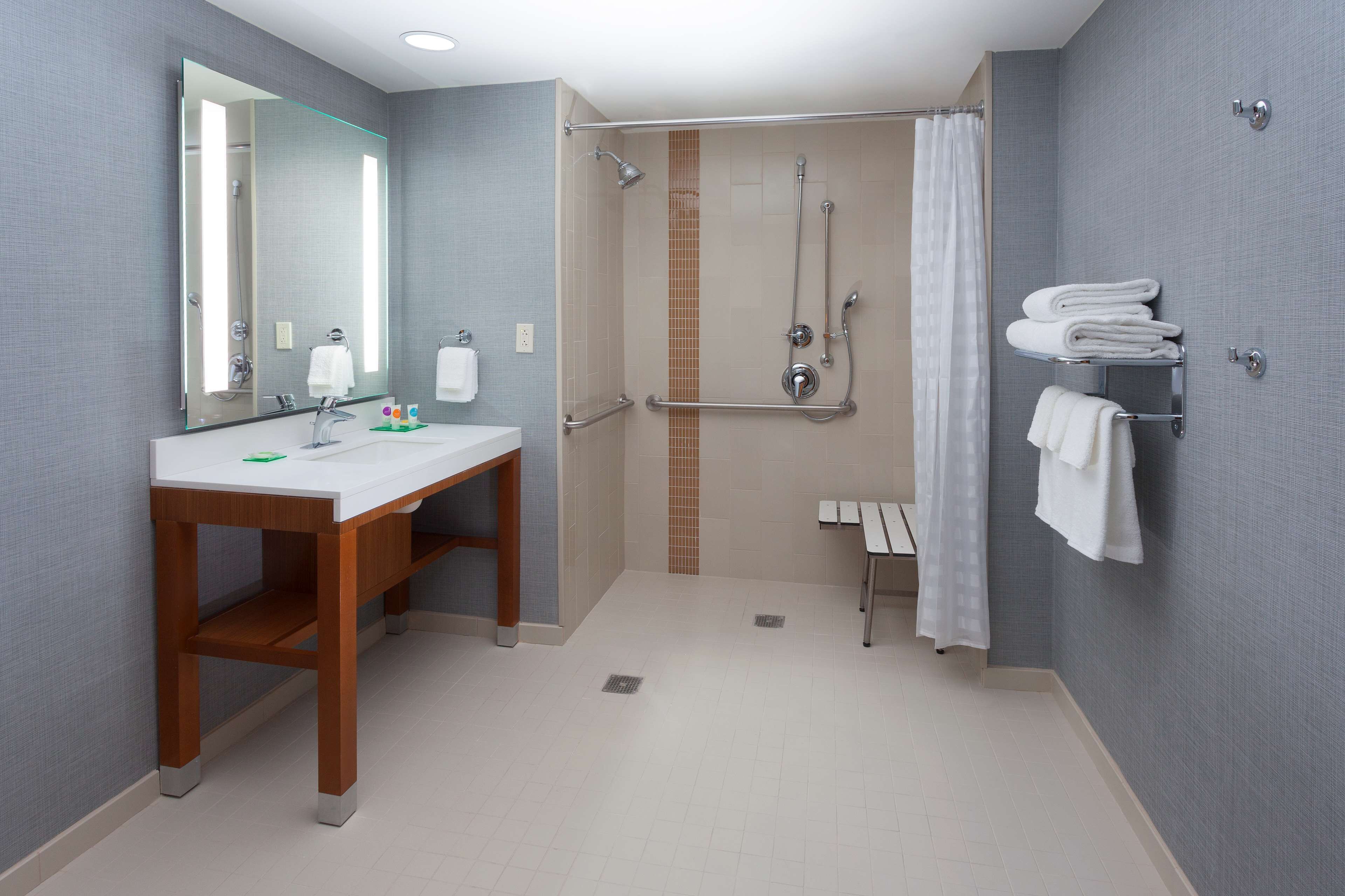 designer toiletries, hair dryer, towels